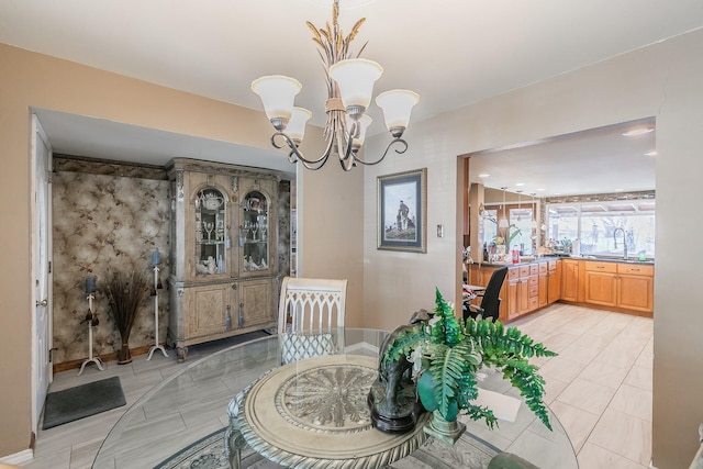 dining room featuring sink and an inviting chandelier