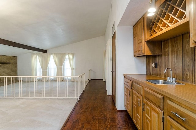 kitchen with dark hardwood / wood-style flooring, sink, and beam ceiling