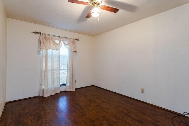 empty room with ceiling fan and dark hardwood / wood-style floors