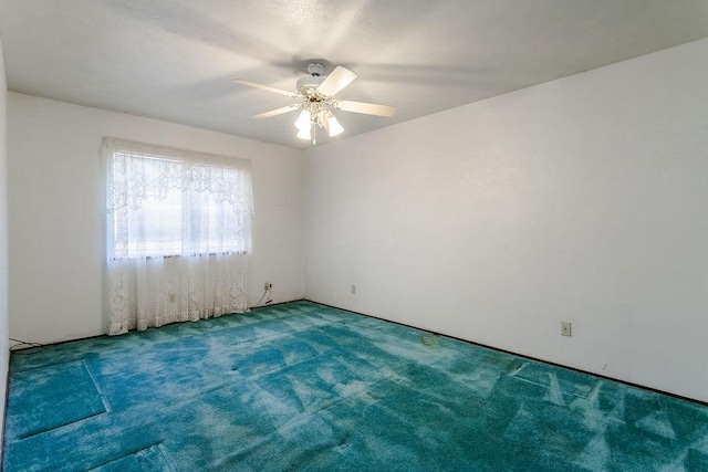 spare room featuring ceiling fan and carpet flooring