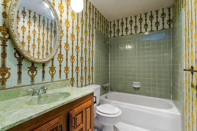 full bathroom featuring vanity, tiled shower / bath, tile patterned flooring, and toilet