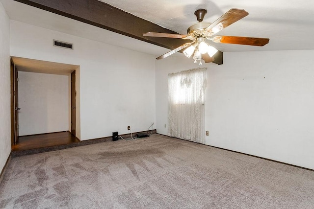 carpeted empty room with ceiling fan and beam ceiling