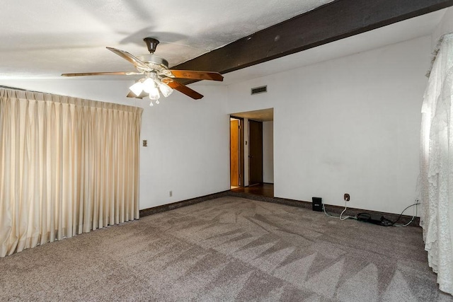 empty room with ceiling fan, beam ceiling, and dark carpet