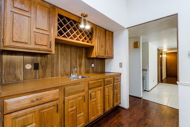 kitchen featuring pendant lighting, sink, and dark wood-type flooring