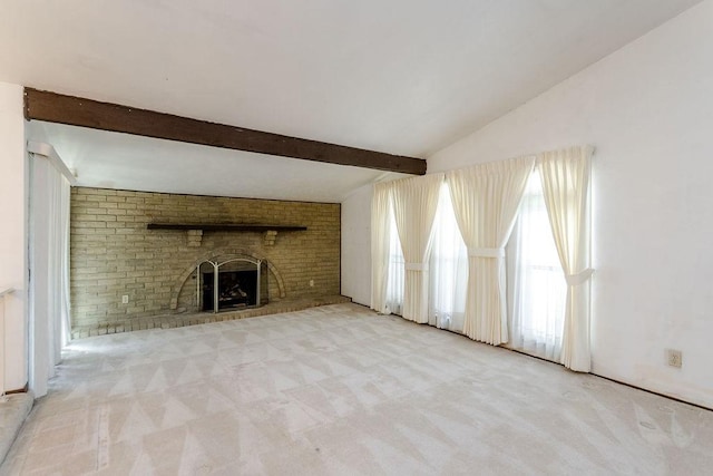 unfurnished living room featuring a fireplace, lofted ceiling with beams, and light carpet