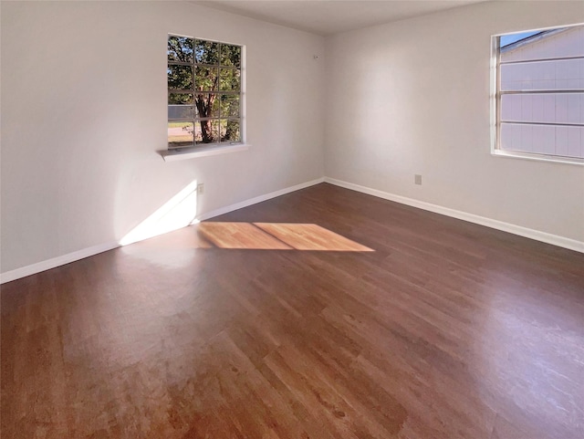 spare room featuring dark hardwood / wood-style flooring