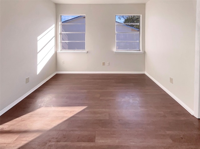 unfurnished room featuring dark wood-type flooring