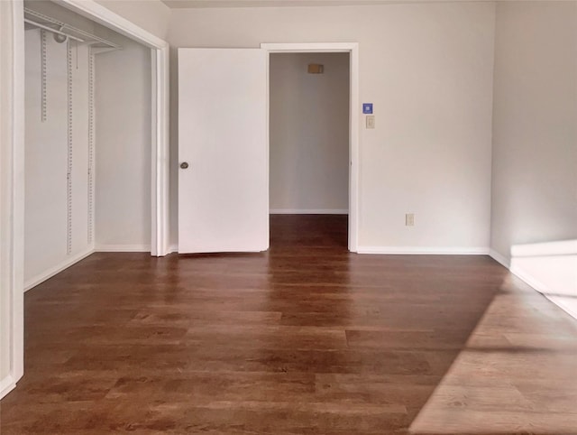 spare room with dark hardwood / wood-style floors