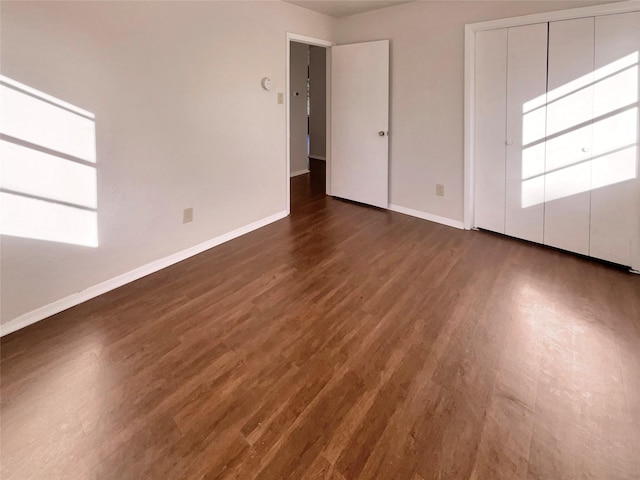 unfurnished room featuring dark wood-type flooring