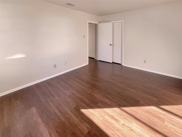 unfurnished room featuring dark hardwood / wood-style flooring