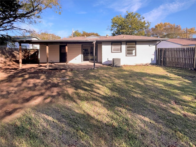 back of house with a patio, central AC unit, and a lawn