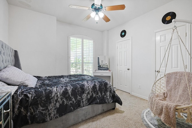 bedroom featuring light carpet and ceiling fan