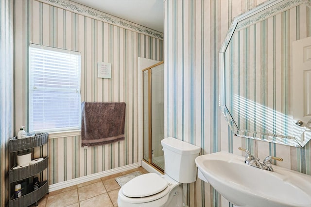 bathroom featuring walk in shower, sink, tile patterned flooring, and toilet