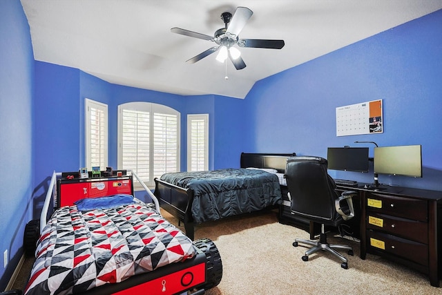 carpeted bedroom featuring vaulted ceiling and ceiling fan