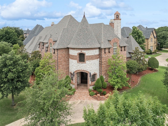 6900 Sir Spencer Ct, Colleyville, TX 76034 - view of front of house with a chimney, stone siding, and a shingled roof