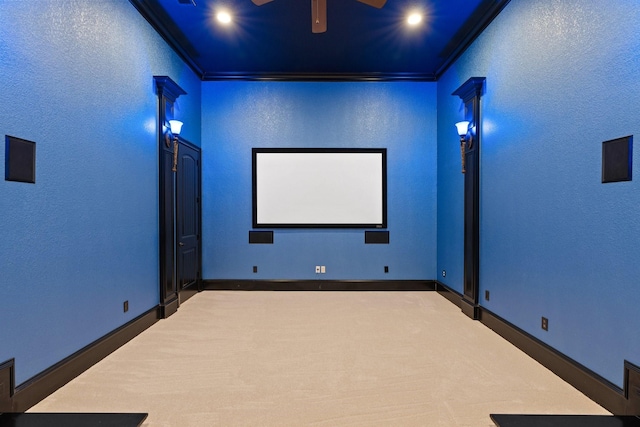 home theater featuring ornamental molding and carpet flooring