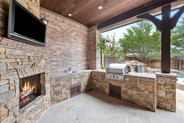 6900 Sir Spencer Ct, Colleyville, TX 76034 - view of patio featuring an outdoor stone fireplace and a sink