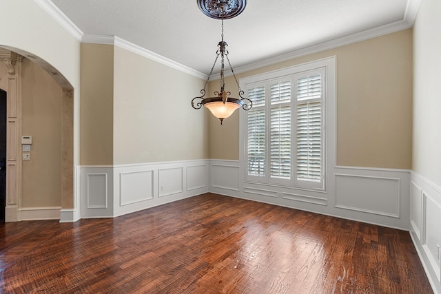 spare room featuring ornamental molding and dark hardwood / wood-style floors