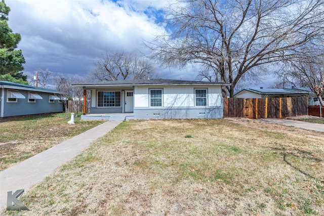 view of front of home with a front yard and fence