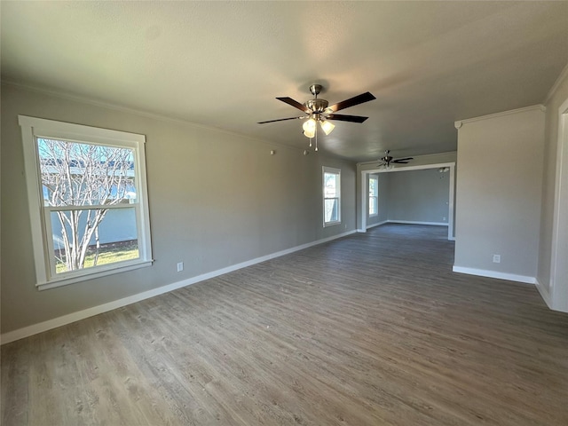 unfurnished room featuring hardwood / wood-style flooring, ornamental molding, and ceiling fan