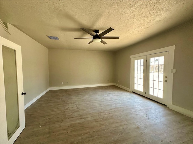 unfurnished room featuring a textured ceiling, dark wood-type flooring, and ceiling fan