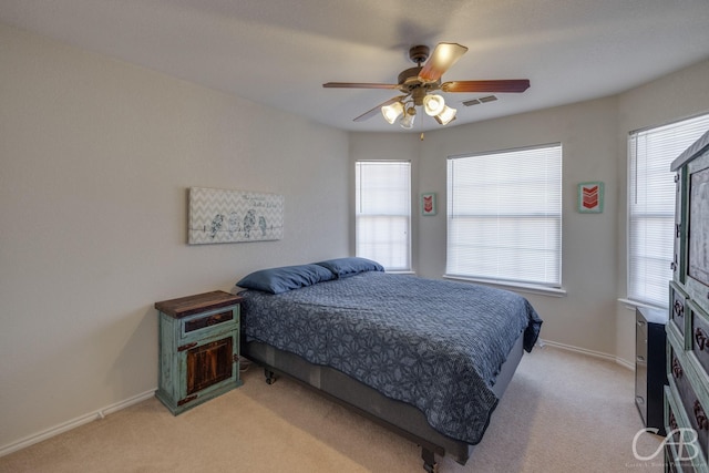 bedroom featuring ceiling fan and light carpet