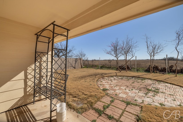 view of yard featuring a rural view and a patio