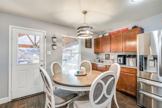 dining space with a wealth of natural light and dark hardwood / wood-style floors