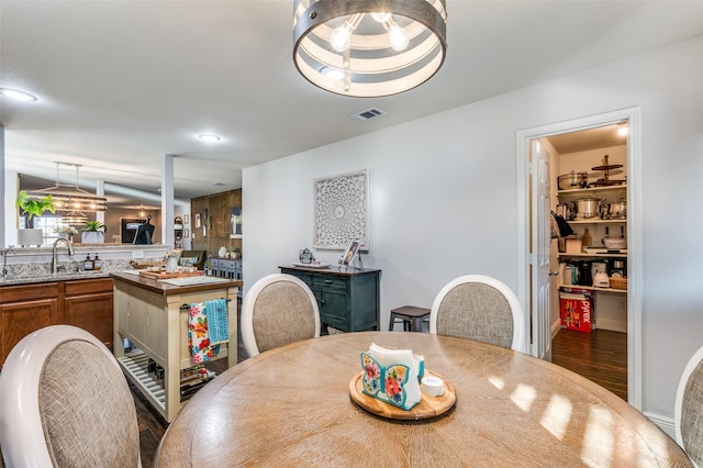 dining area featuring sink and dark hardwood / wood-style flooring