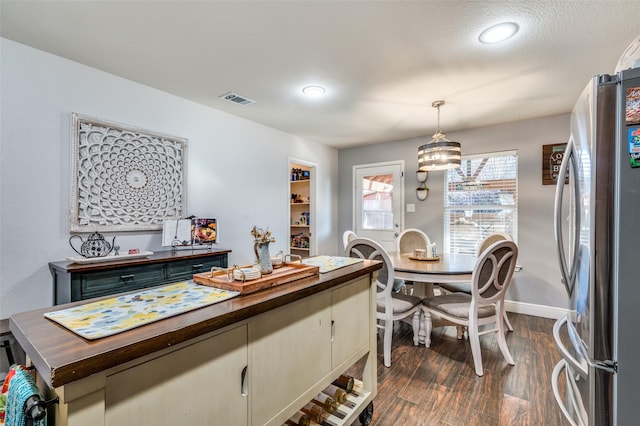 dining space featuring dark hardwood / wood-style floors and a textured ceiling