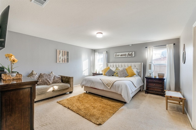 bedroom featuring light carpet