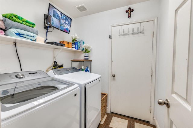 laundry area with independent washer and dryer