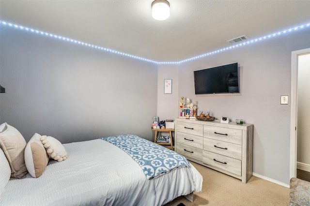 bedroom with light colored carpet