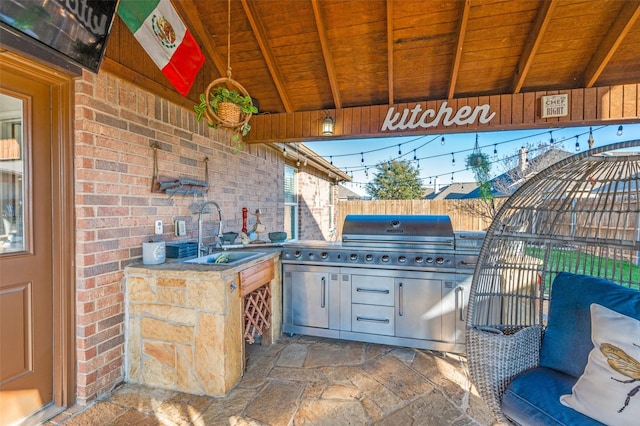 view of patio / terrace featuring exterior kitchen, a grill, and sink