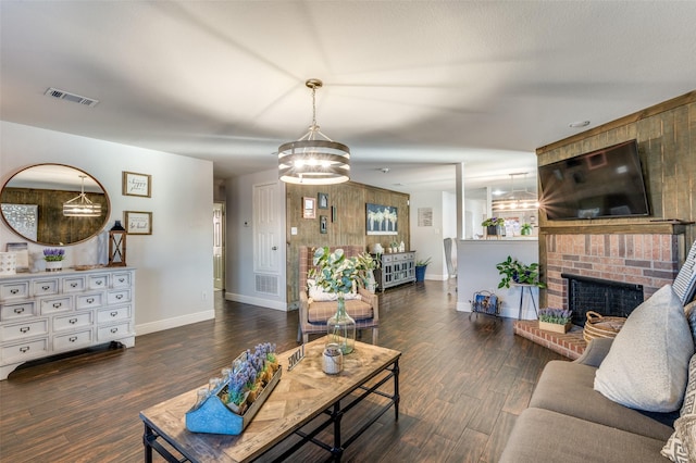 living room with a fireplace and dark hardwood / wood-style flooring