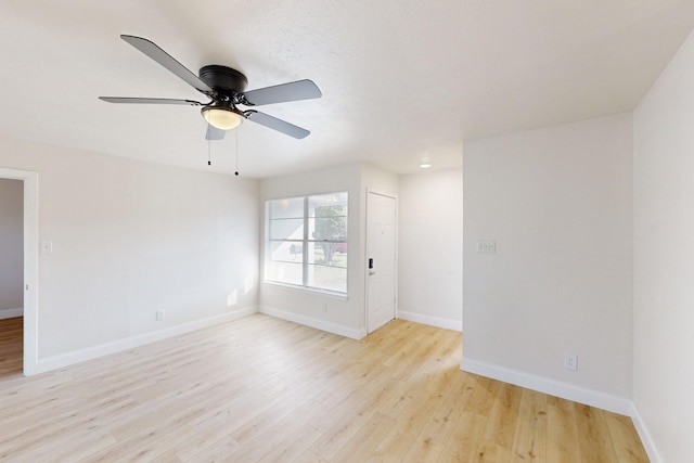 spare room with ceiling fan and light hardwood / wood-style flooring