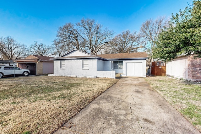 single story home with a garage and a front lawn