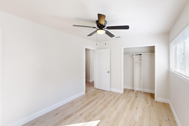 unfurnished bedroom with light hardwood / wood-style floors, a closet, and ceiling fan