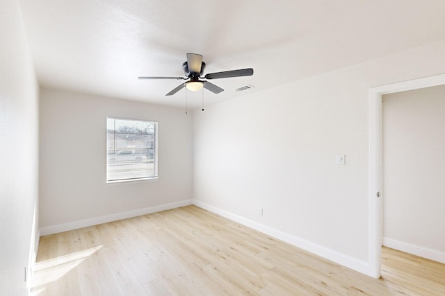 spare room with ceiling fan and light wood-type flooring