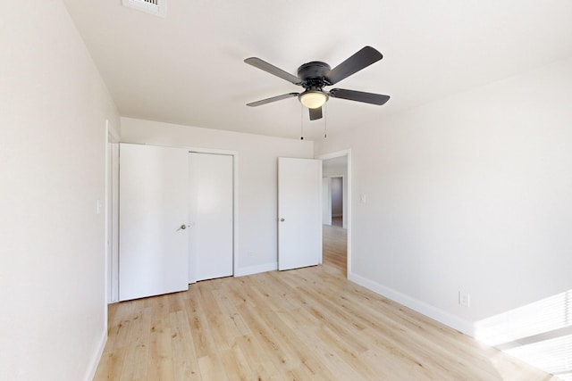 unfurnished bedroom featuring a closet, ceiling fan, and light wood-type flooring