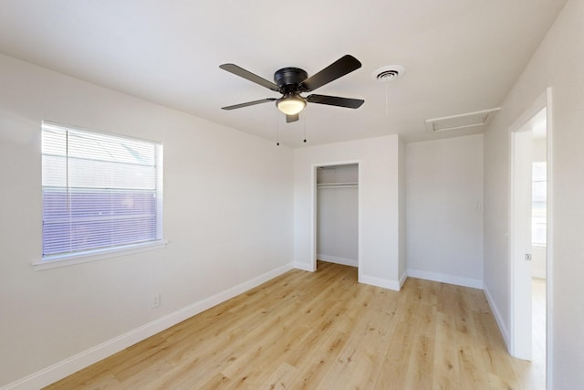 unfurnished bedroom featuring ceiling fan, light wood-type flooring, and a closet