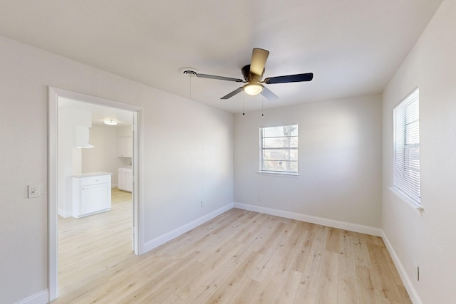 unfurnished room featuring ceiling fan, a healthy amount of sunlight, and light hardwood / wood-style flooring