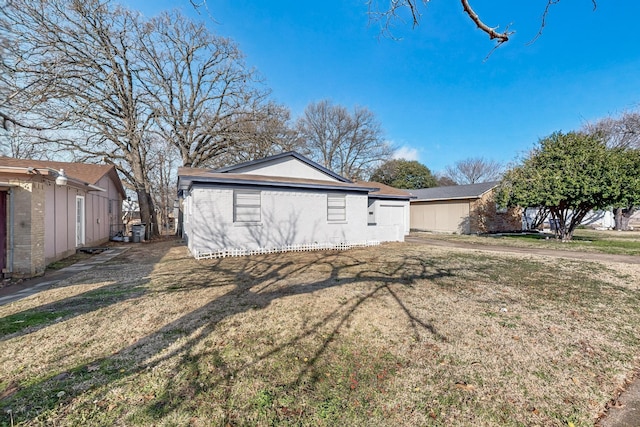 view of side of home featuring a lawn