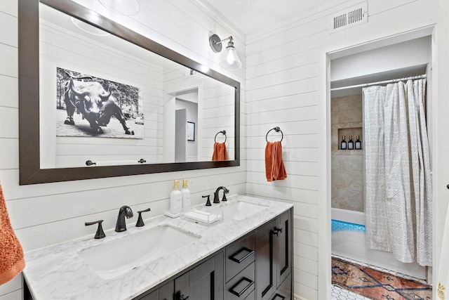 bathroom featuring shower / bath combination with curtain, ornamental molding, vanity, and wood walls