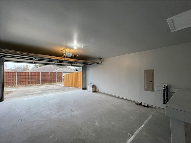 garage with a garage door opener and electric panel