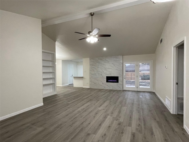 unfurnished living room with ceiling fan, high vaulted ceiling, a large fireplace, dark hardwood / wood-style flooring, and beamed ceiling