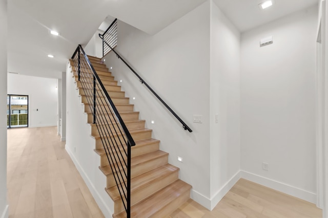 stairway featuring wood-type flooring