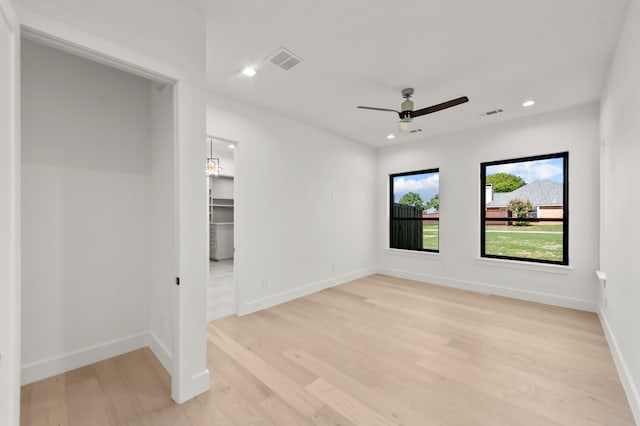 spare room with ceiling fan and light hardwood / wood-style flooring