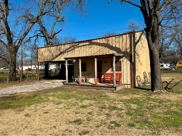 back of property with a lawn