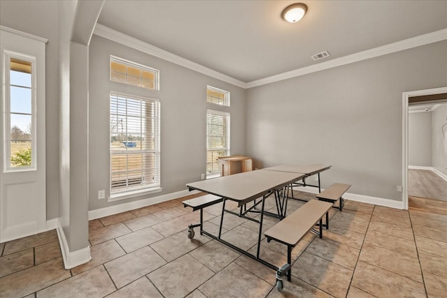 tiled dining room featuring ornamental molding